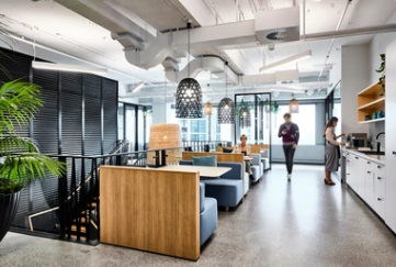 a coworking space with a dining area and coffee machine