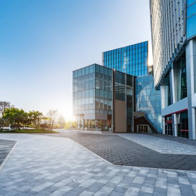 Modern glass panel office building with sun shining